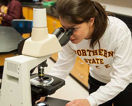 Woman student at microscope