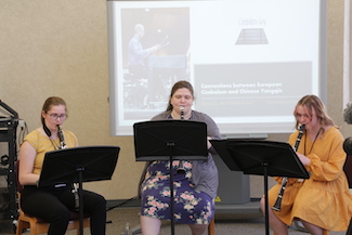 Three female students playing clarinets