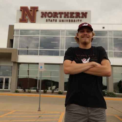 Carter Moller stands outside of the Barnett Center