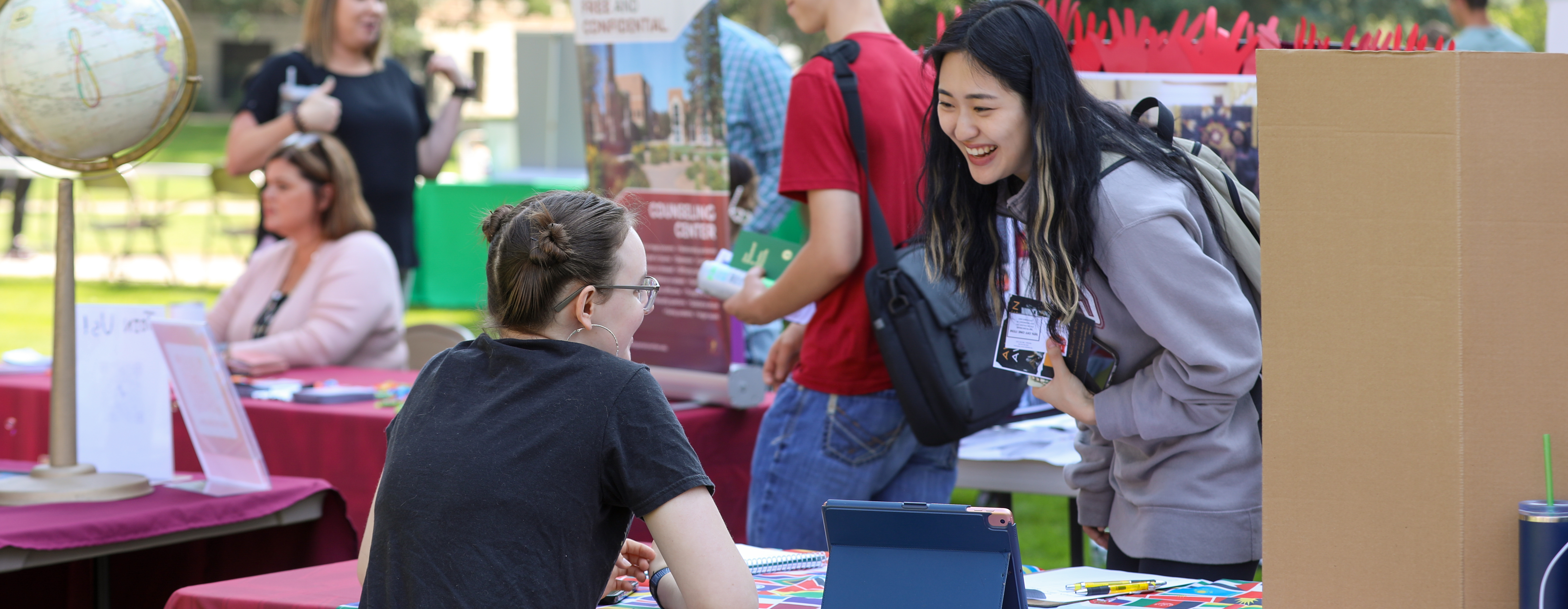 Photo of students and NSU representatives at an outdoor gathering.