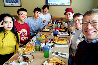International students eat lunch with their friend family