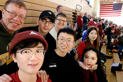 International students attend a sports game with their friend family