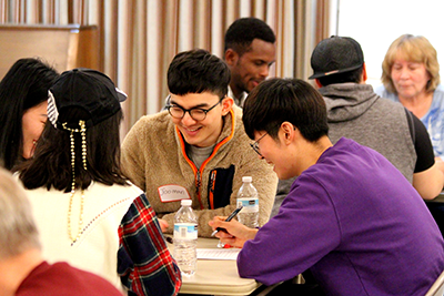 International students wear nametags at a table