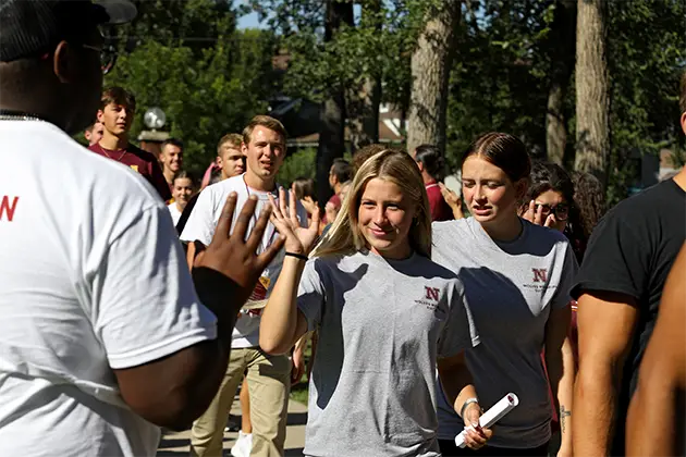 A group of student give one another high fives