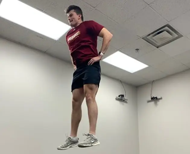 Student doing a vertical jump in the Sports Sciences Lab