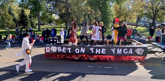 YMCA float drives down Main Street as an Elvis impersonator walks alongside