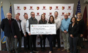 Officials receiving a large check for the Knight grant