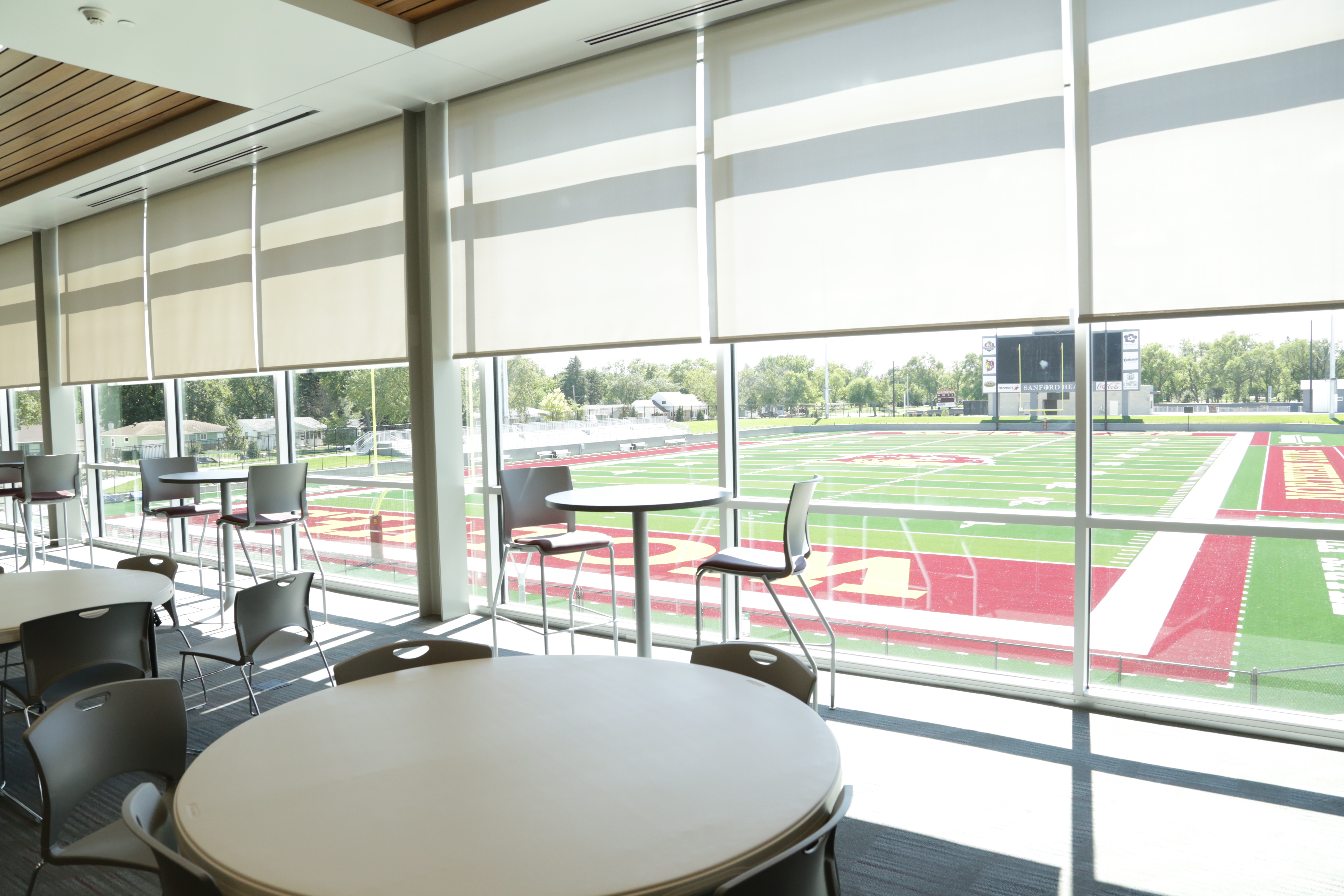 Tables and chairs in a room with tall windows