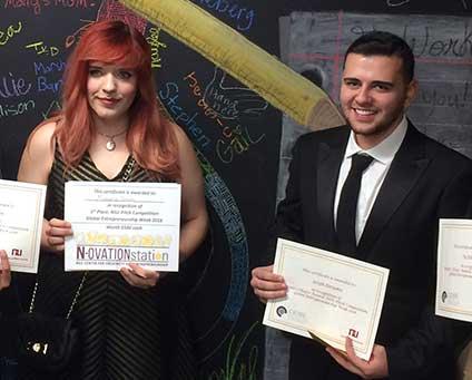 Two students showing scholarship awards