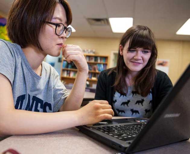 Two students on laptop computer