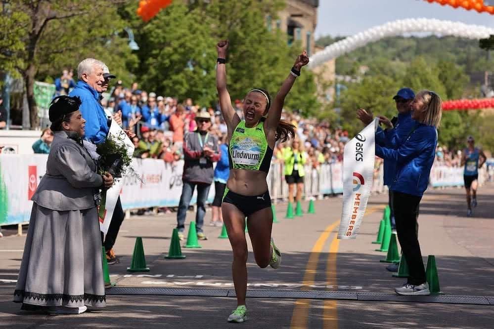 Dakotah Lindwurm cheering as she wins her second Grandma's Marathon