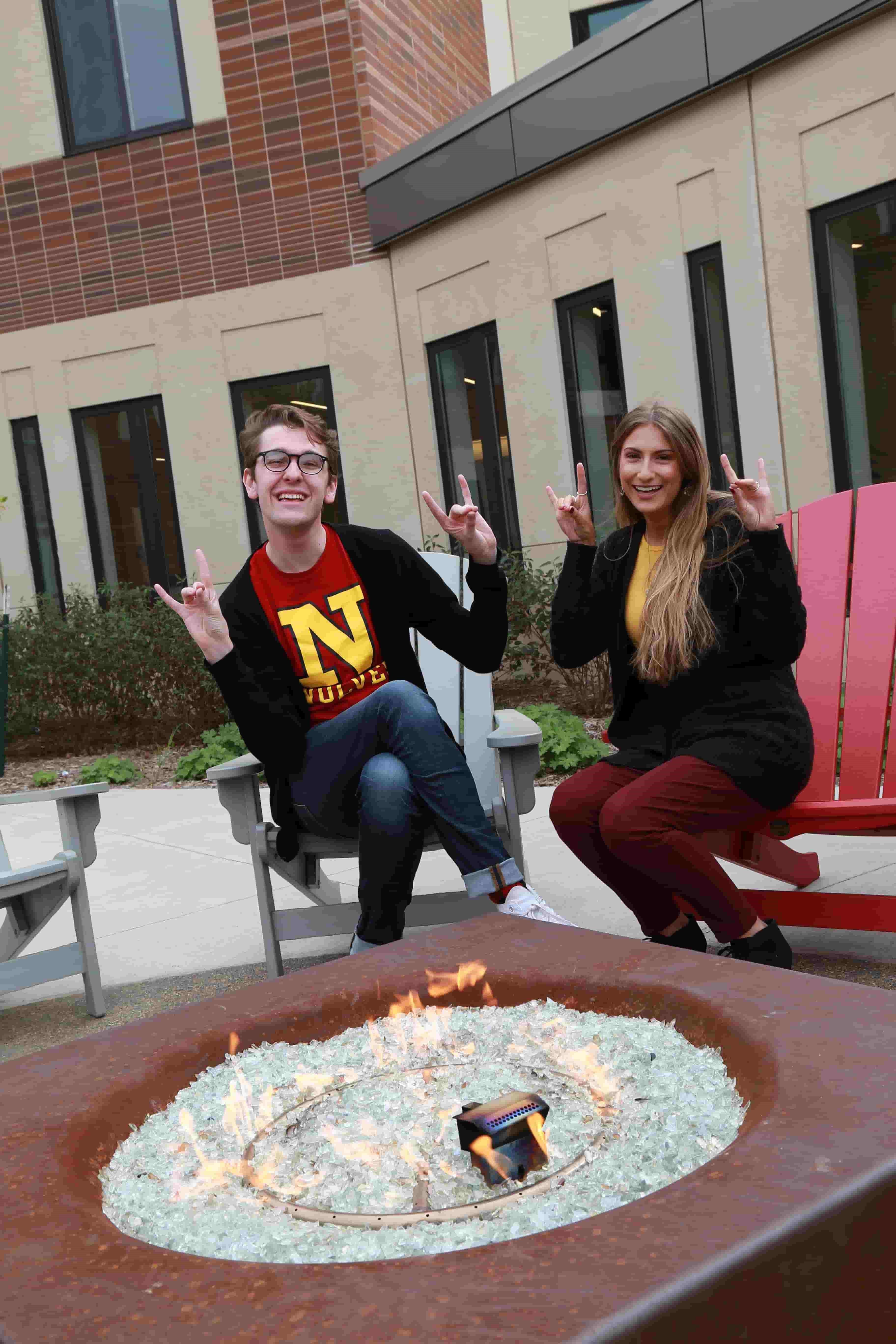 NSU students sitting near firepit