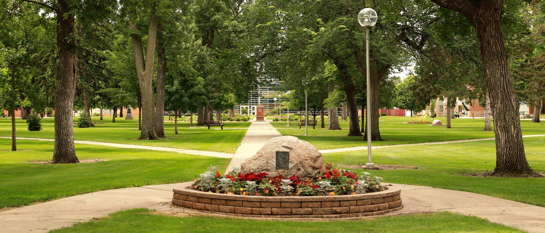 A large decorative rock at campus entrance
