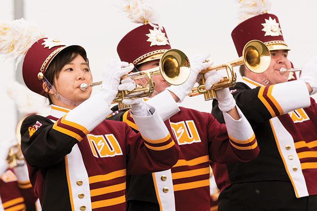 Three trumpeteers in marching band
