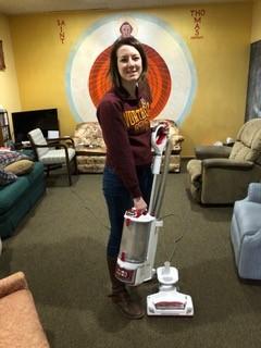 Student volunteering with vacuum