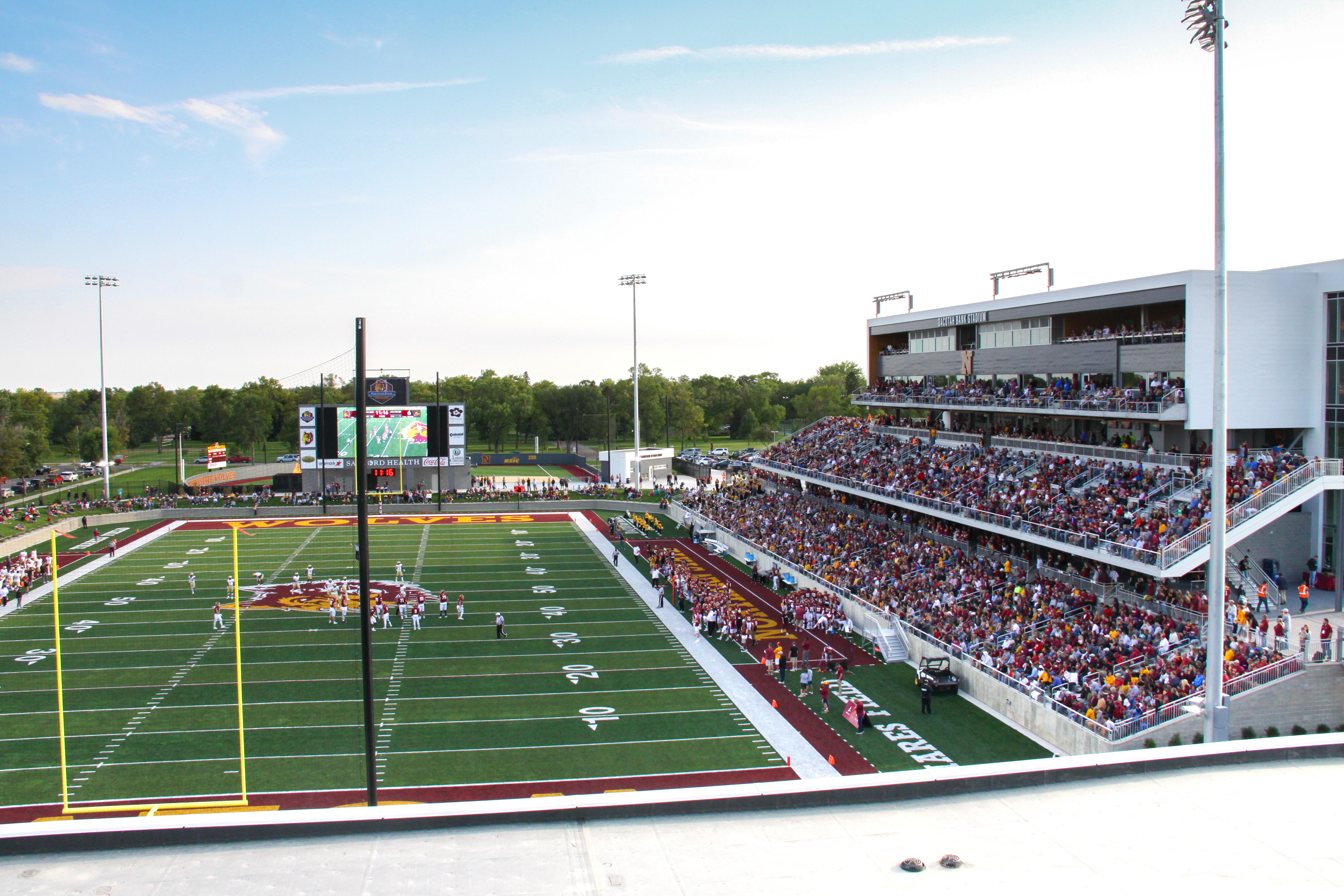 View of packed Dacotah Bank Stadium during a football game