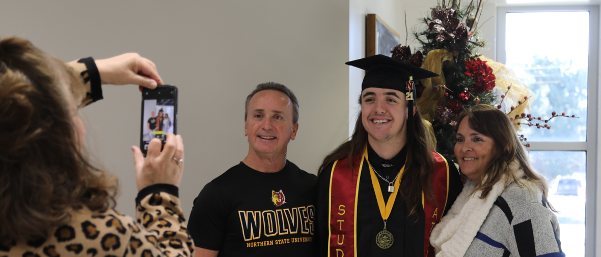 A family poses for a photo on graduation day