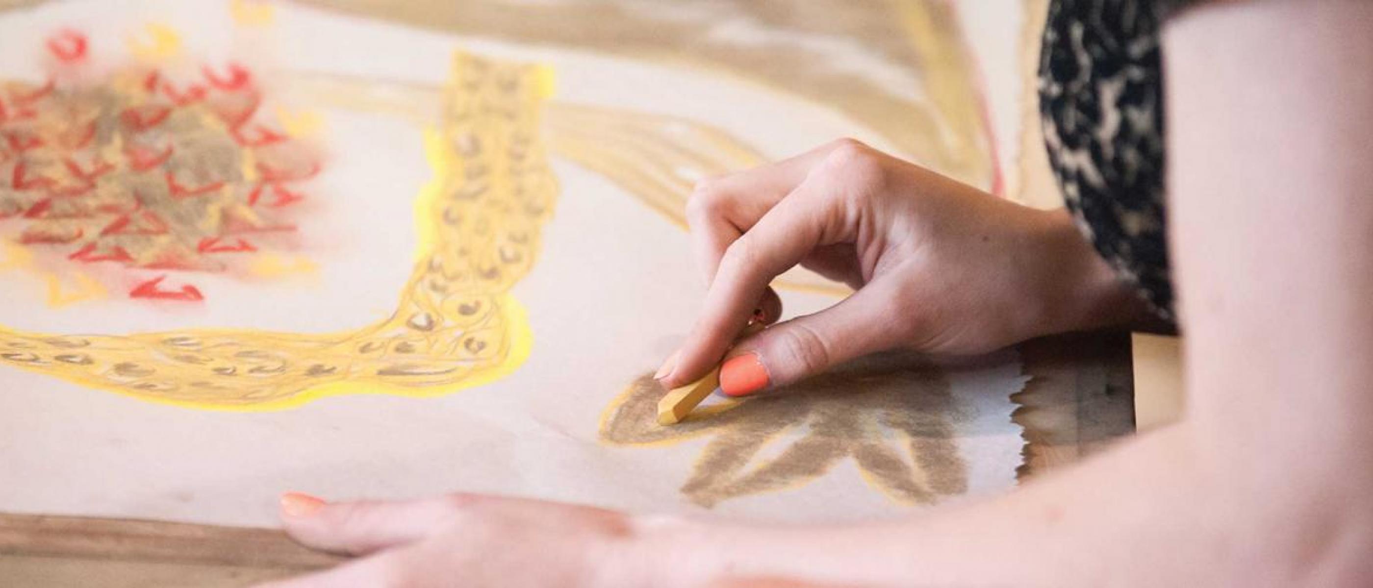 Artist creating beautiful drawing with chalk