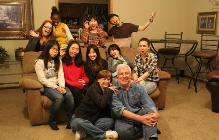 The Bieglers and Friendship Family Program participants posing and smiling together in family's living room