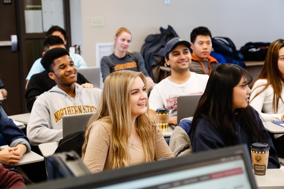 Group of students sitting in class smiling