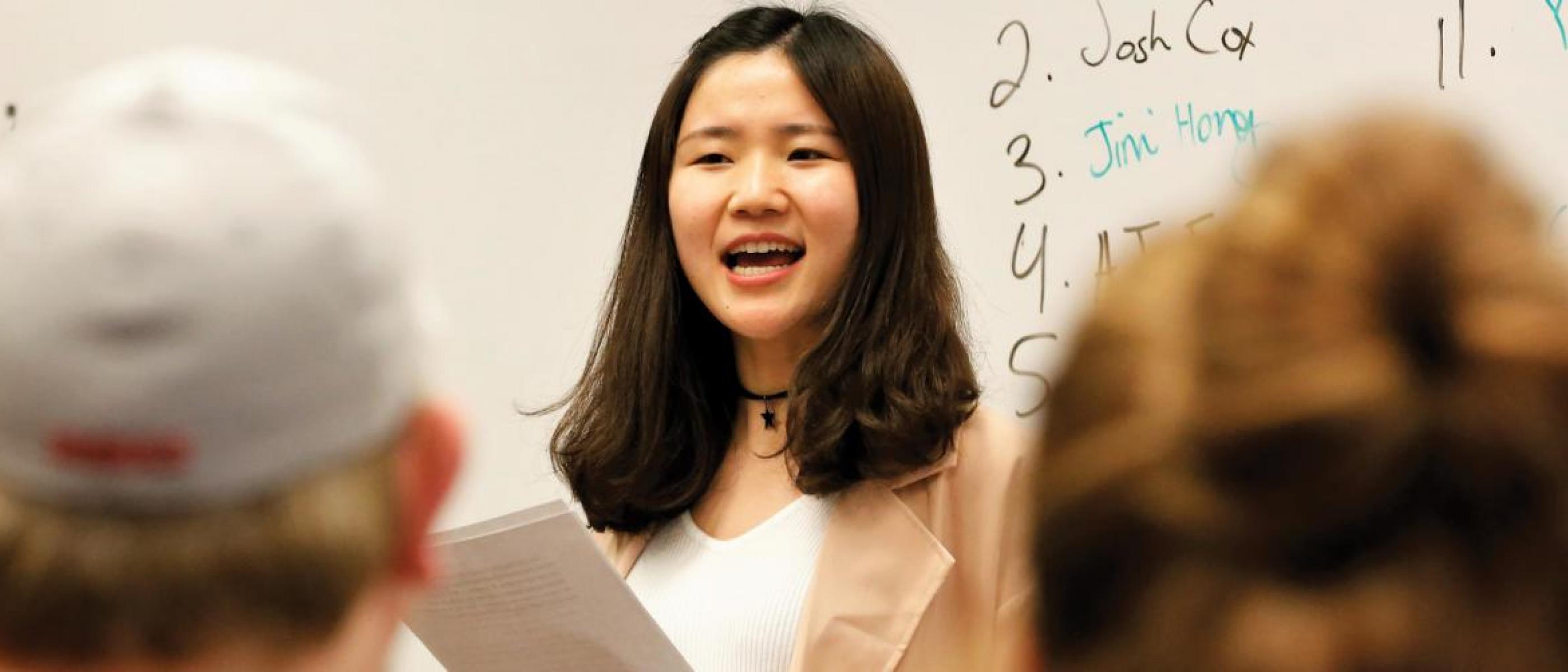 Student speaking in front of class