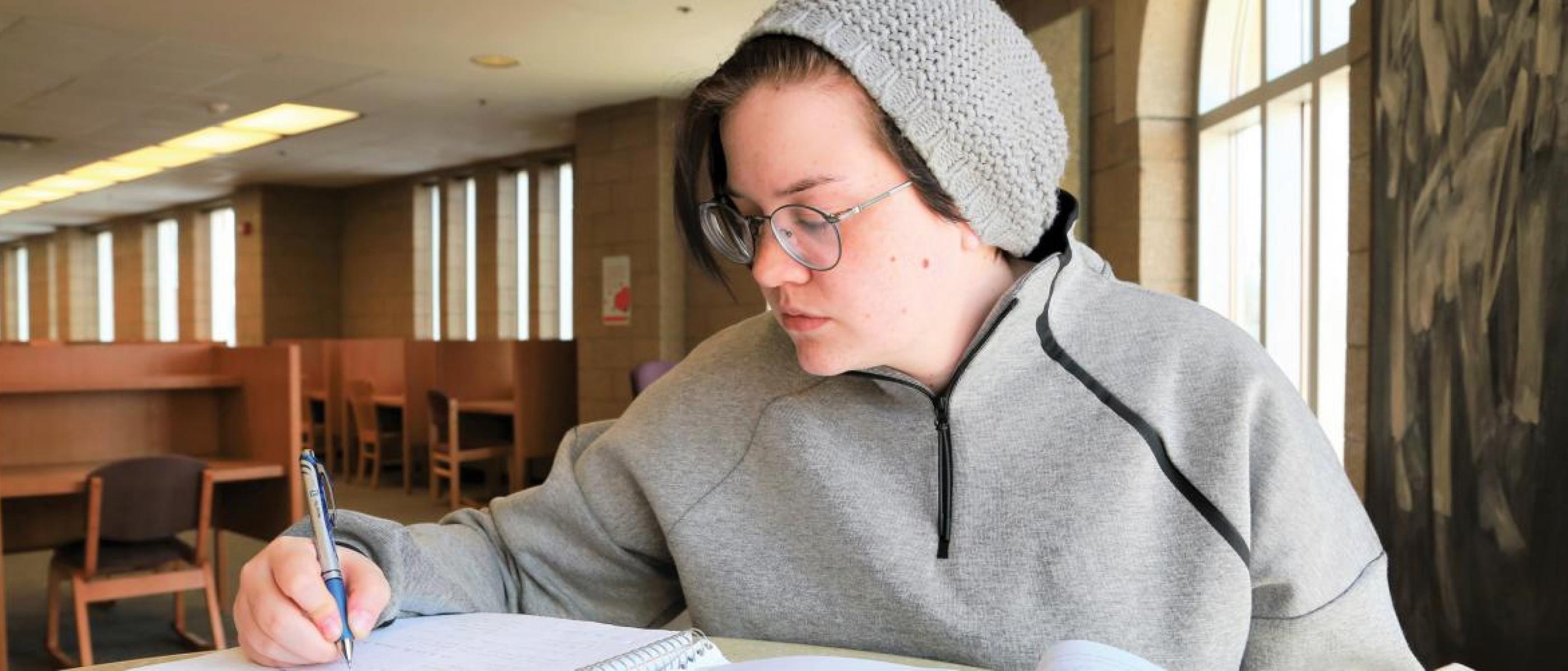 Student doing homework in the library