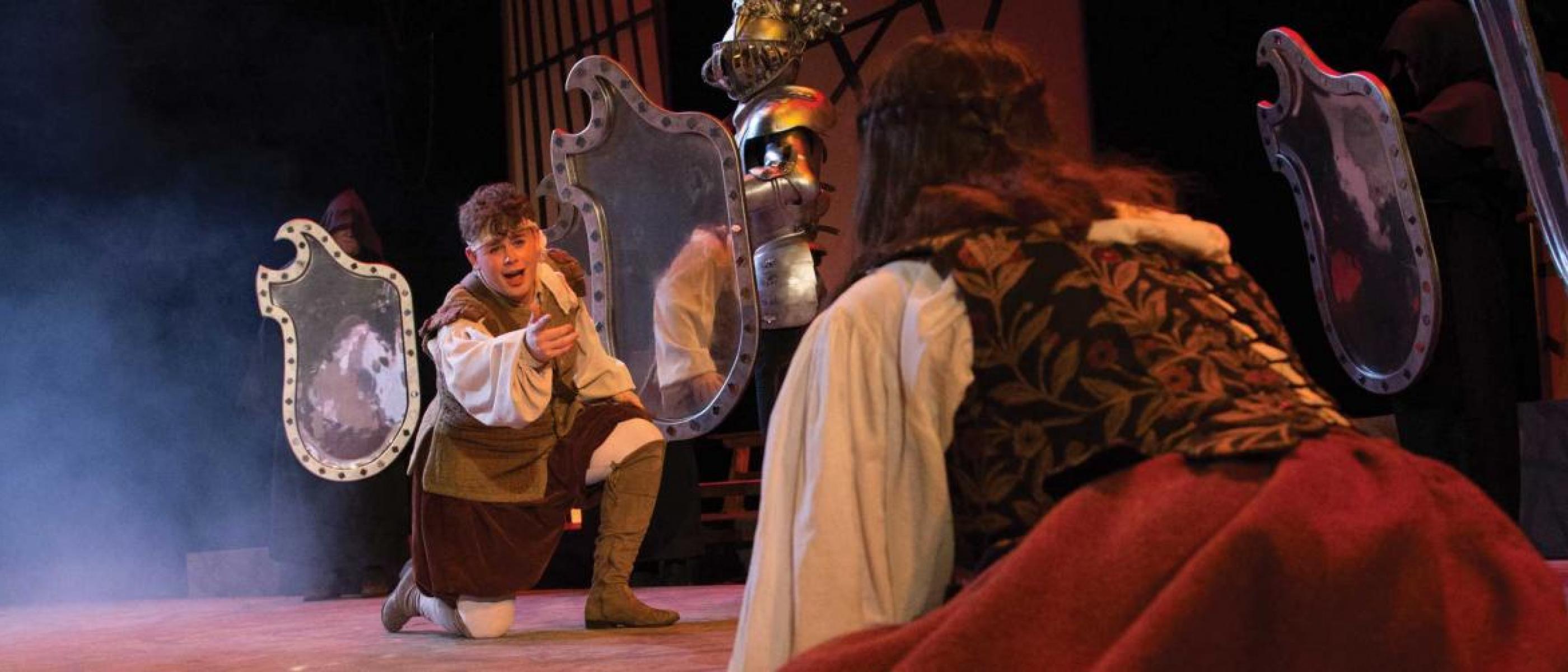 Students performing in a play on stage