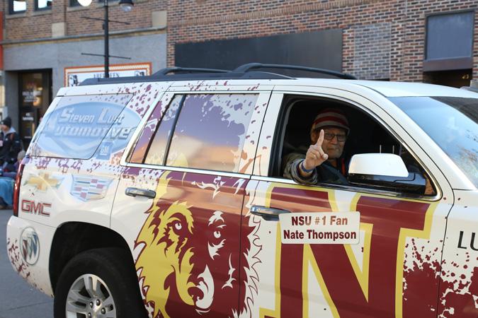 NSU No. 1 fan Nate Thompson rides in an NSU van in the parade
