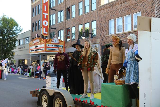 Parade float participants are dressed as Wizard of Oz characters