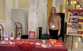Megan Fastenau standing by the NSU table at the Capitol in Pierre
