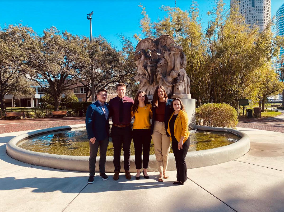 Five students standing together 