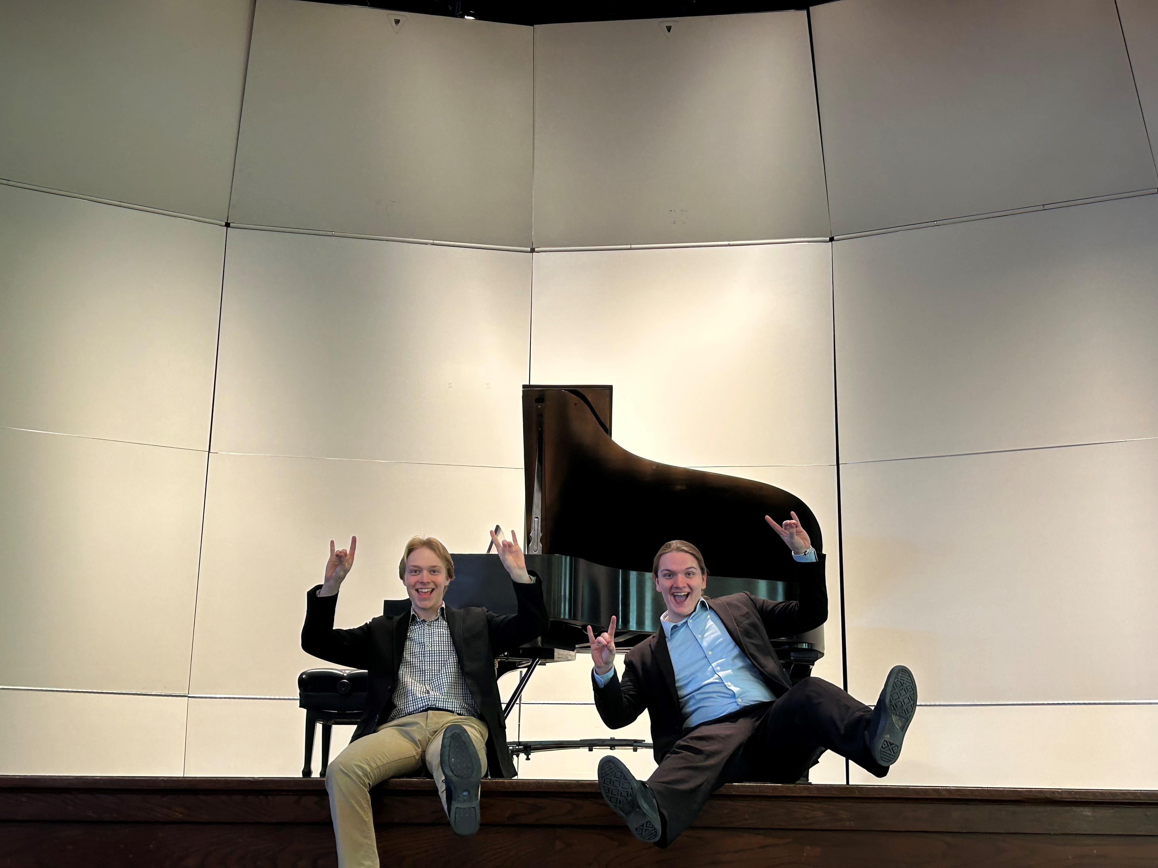 NSU students Tanner Pietz and Justin Desens in front of a piano
