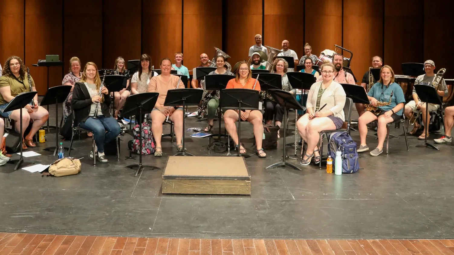 A group of musicians smiles on stage
