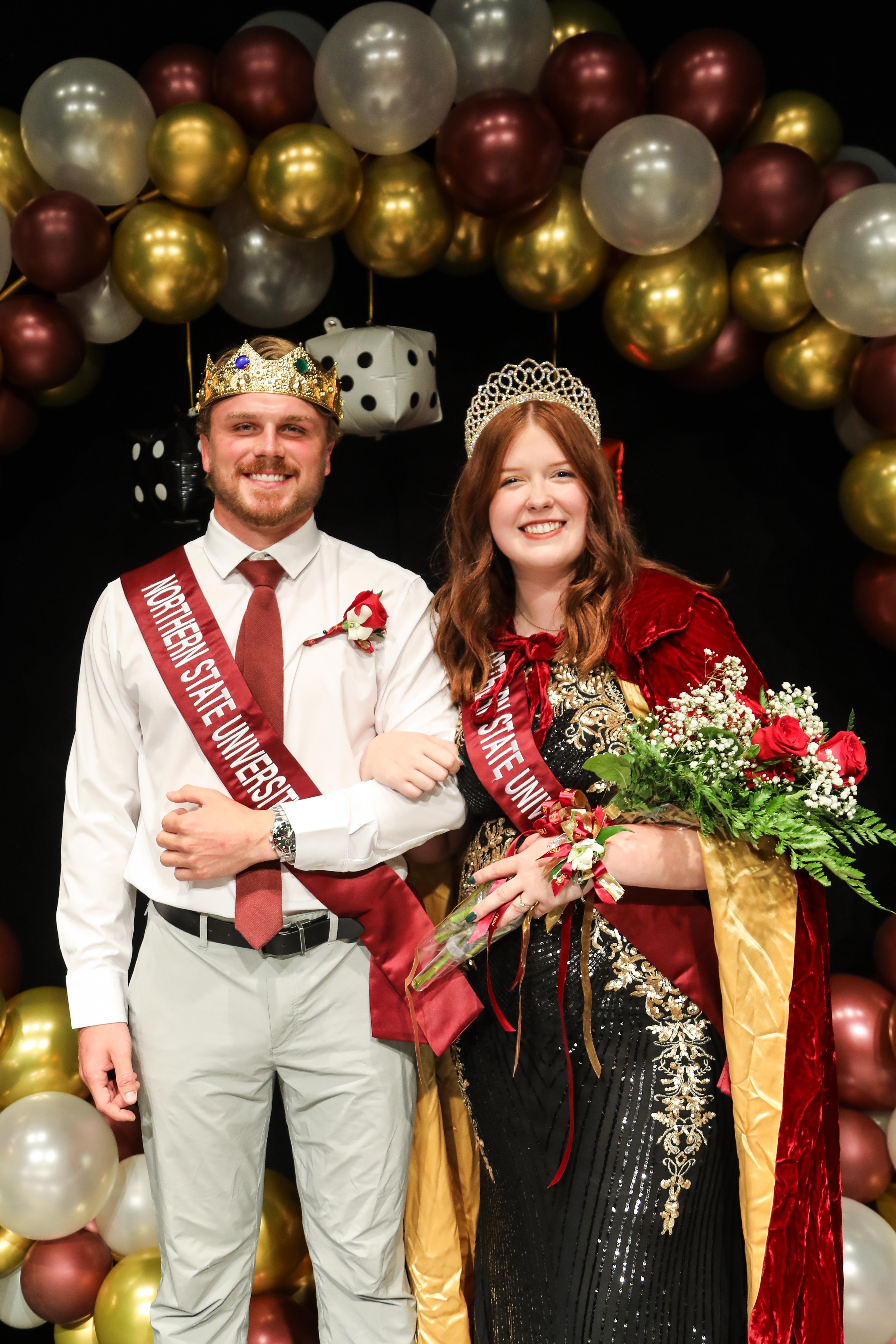 Clayton Randall and Kayla Jensen stand arm-in-arm after being crowned Homecoming King and Queen