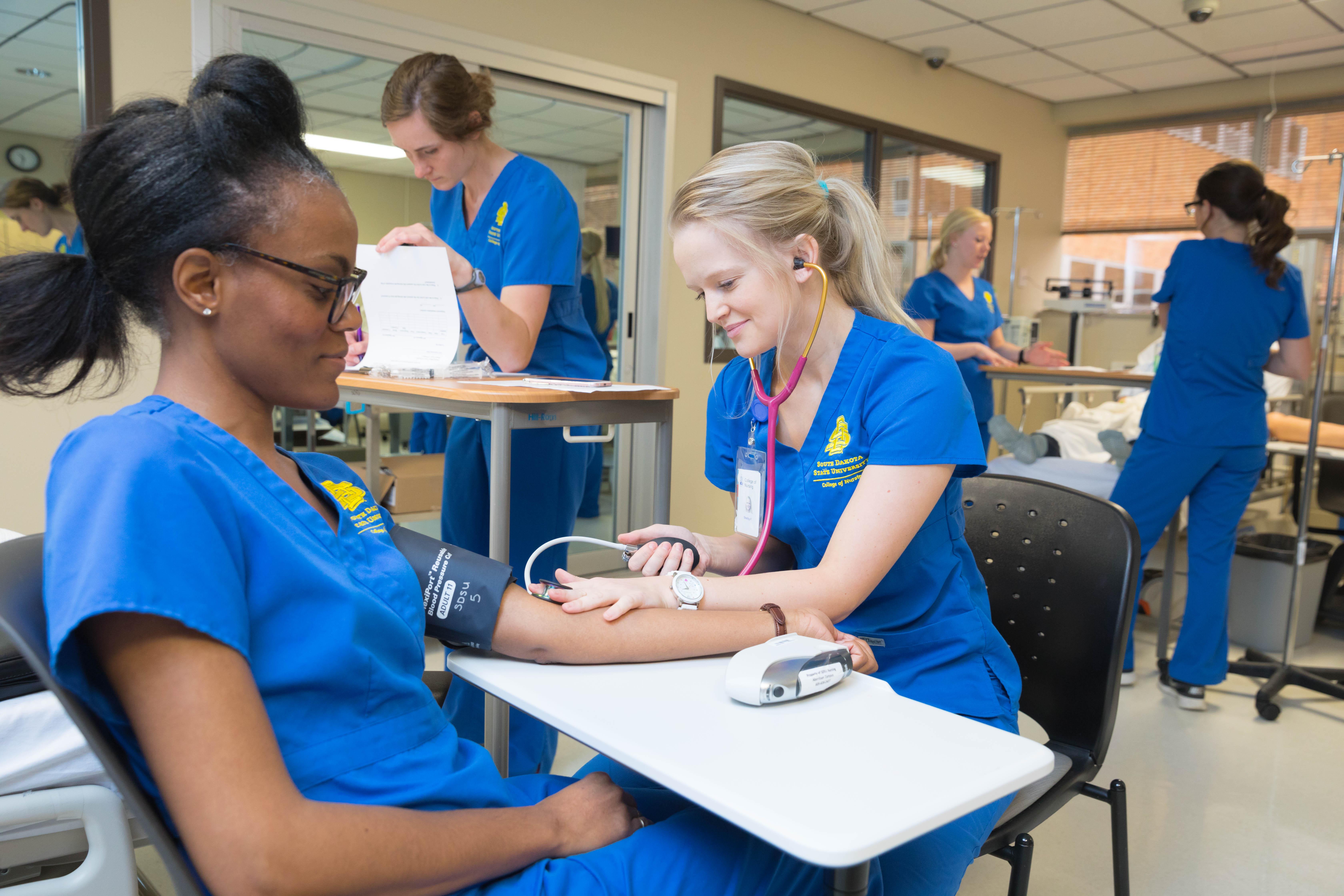 Students in SDSU's nursing program practice taking each other's blood pressure