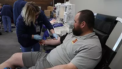 A person donates blood at a Northern blood drive