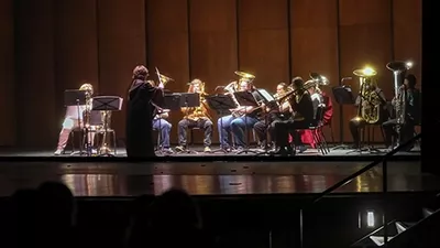 Brass musicians perform on stage