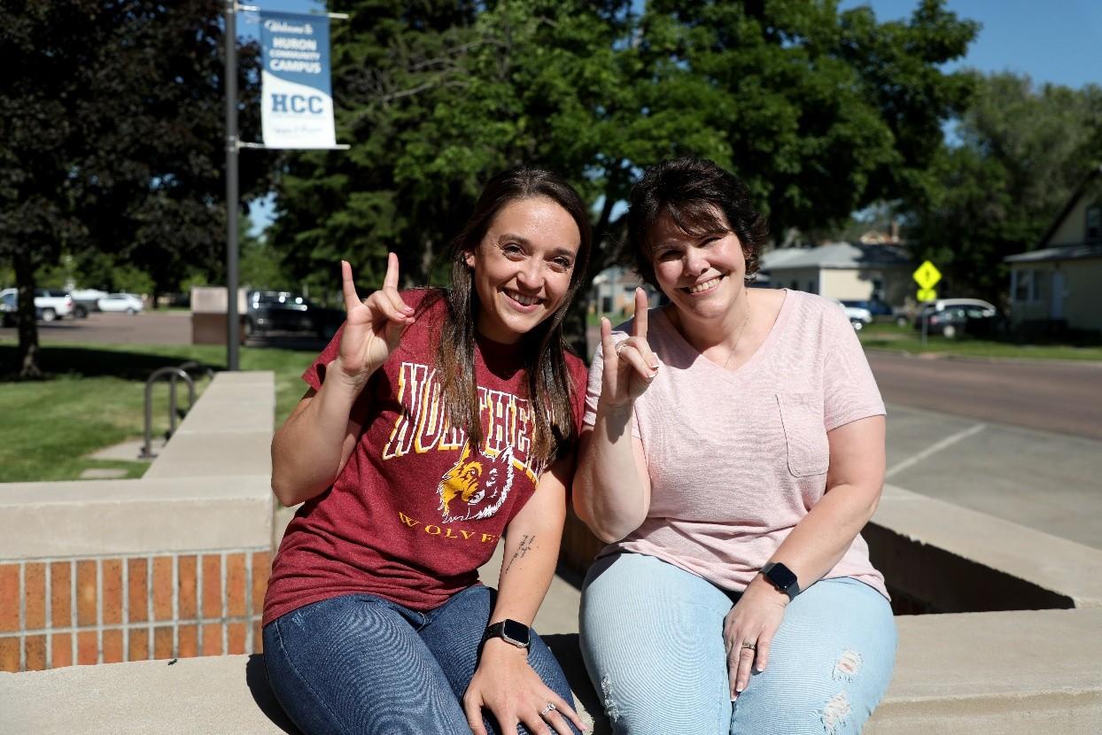 Two graduate students smiling at the camera