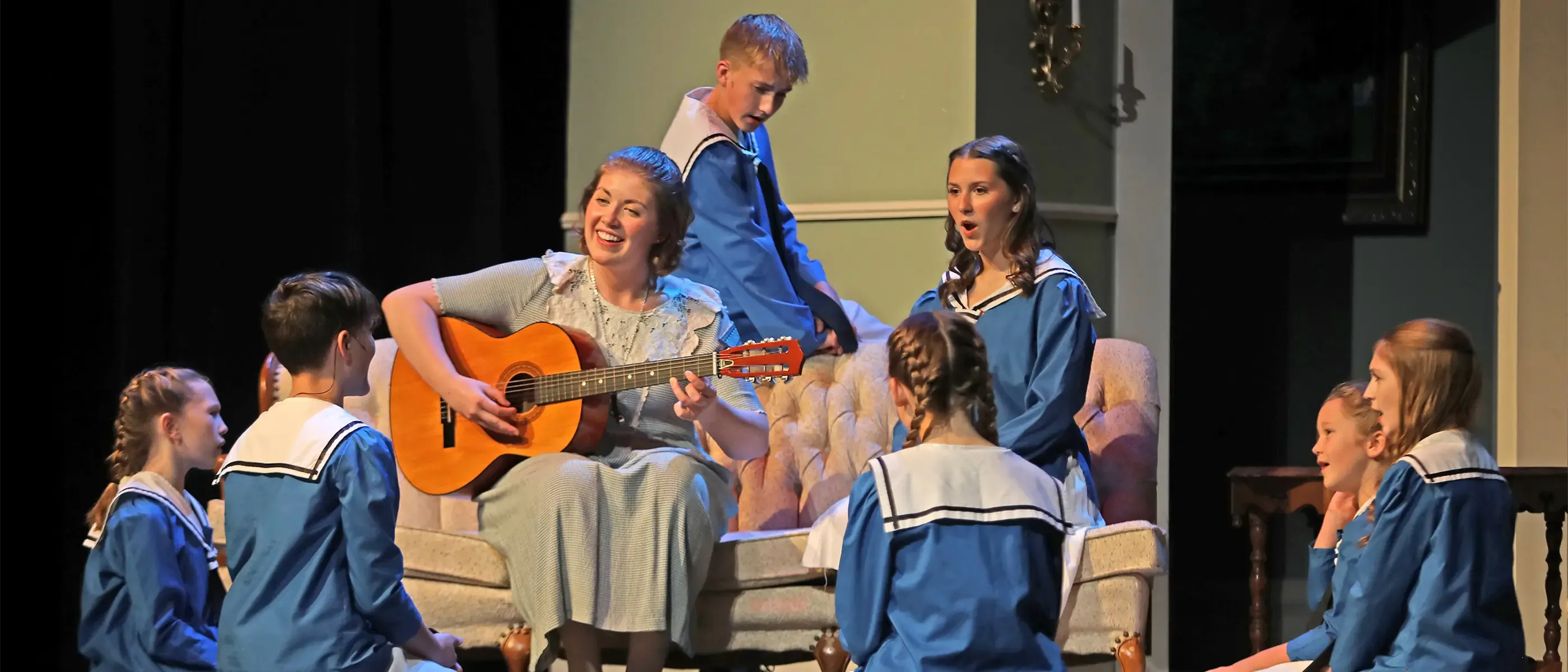 Sound of Music Production - Mary Poppins plays a guitar for 7 children