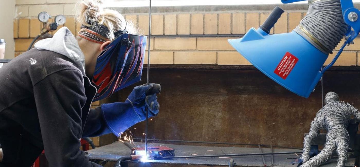Female art student welding