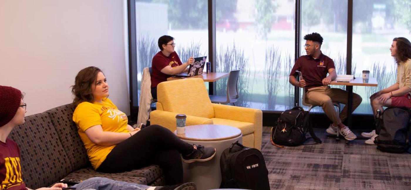 Students rest and recreate in a dorm lounge