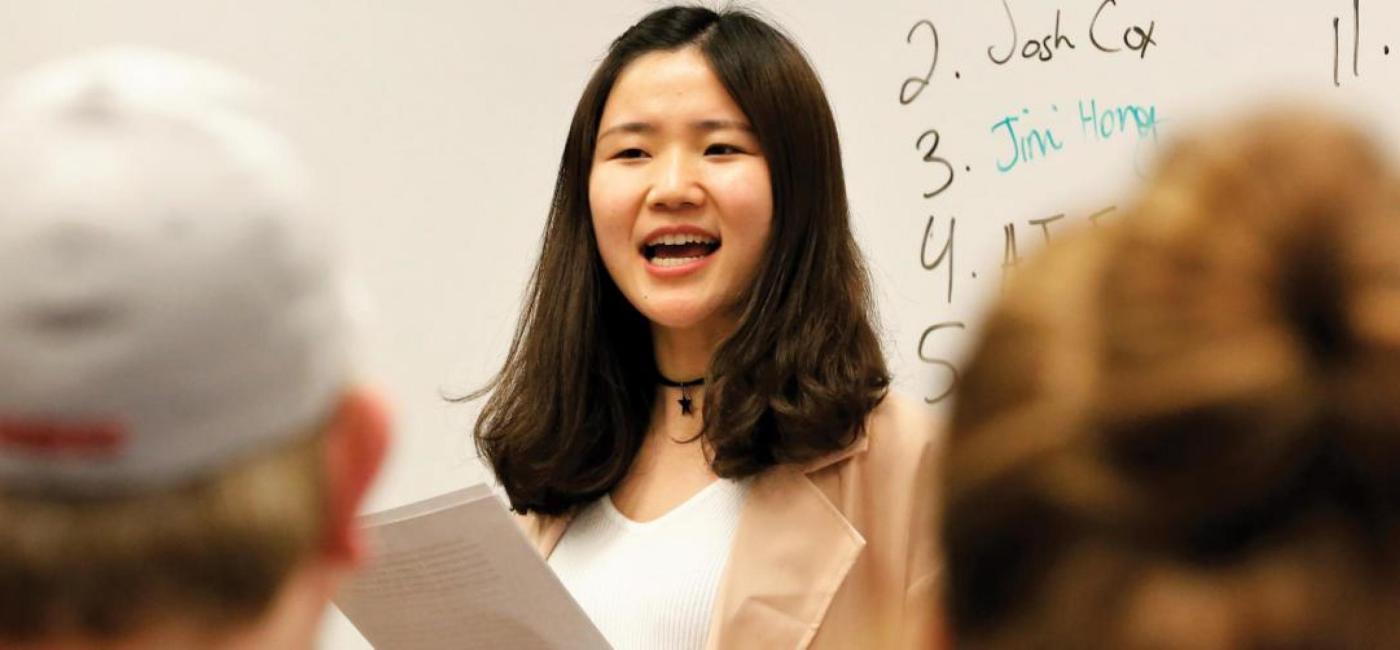 Student speaking in front of class