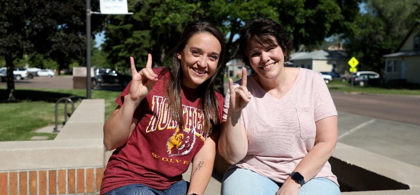 Two graduate students smiling at the camera