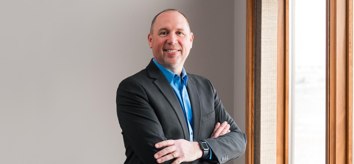 Portrait of a man in a suit standing near window office