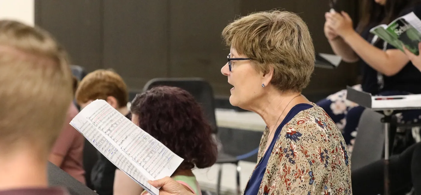 Senior woman singing in a choir