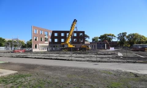 Photo of large crane near two walls of building