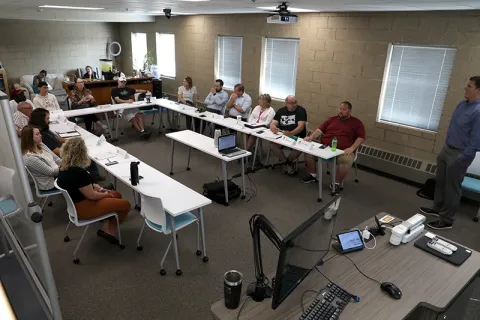 People sit around a table at the startup center funding workshop