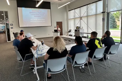 People view a business-launching presentation