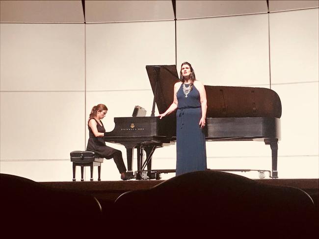 Woman playing piano while another woman sings