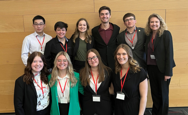 A group of college students and professor at an undergraduate honors conference